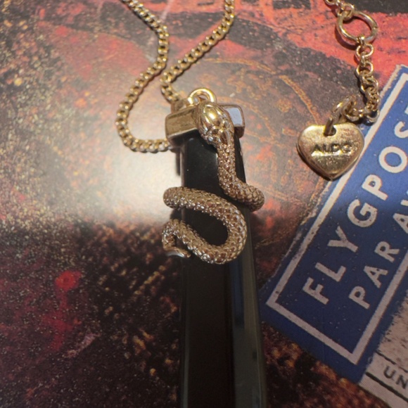 Gold tone snake pendant necklace on black onyx point.   Aldo tag on chain. - Picture 4 of 5